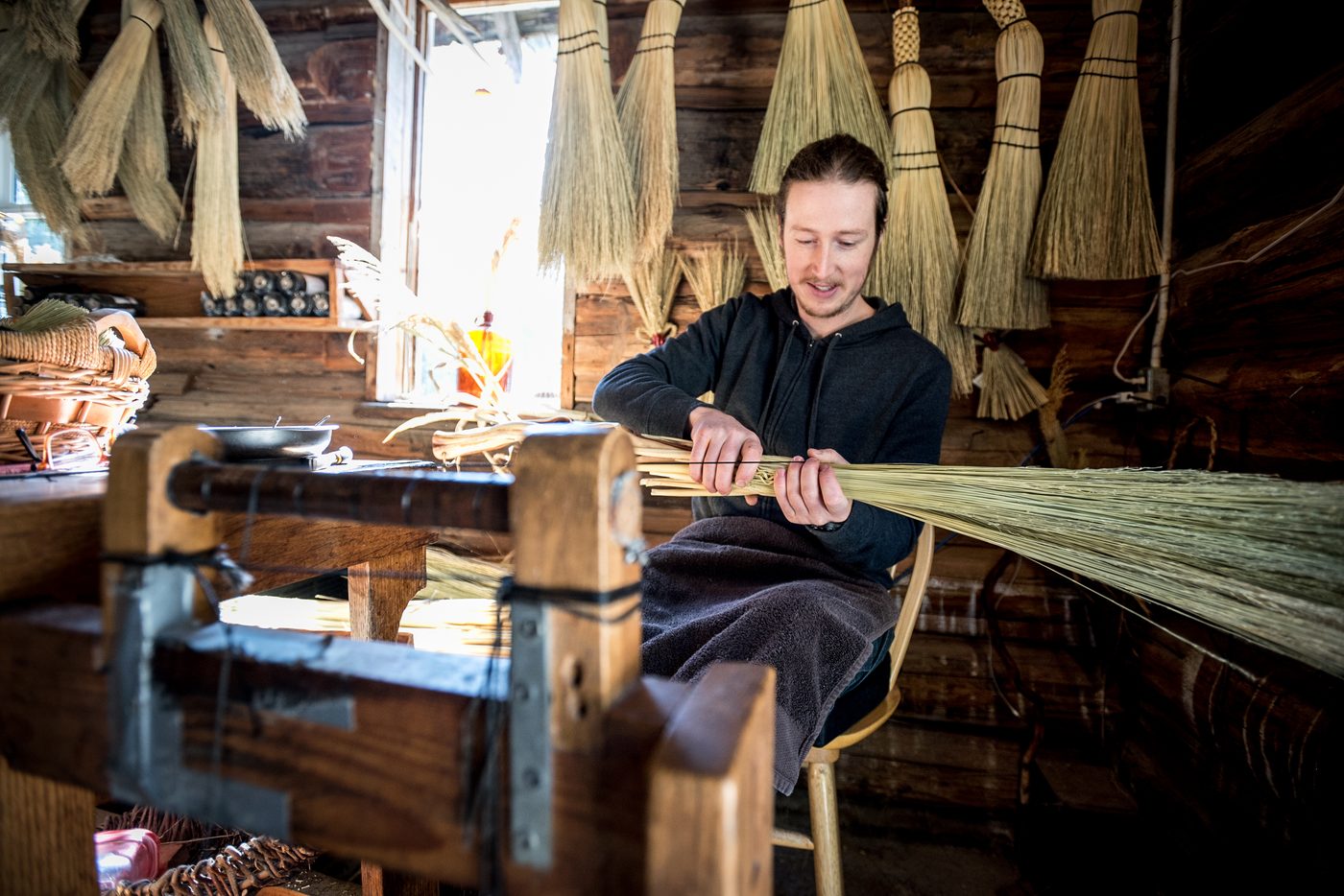 Luke Lewis weaving a broom